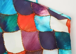 Close-up of colorful fish scale print on polyester dress showing detailed stitching work