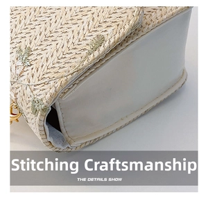 Close-up of woven straw saddle bag featuring delicate leaf embroidery and stitching