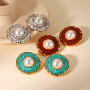 Detail of vintage French style round pearl earrings in silver, vermilion and lake blue