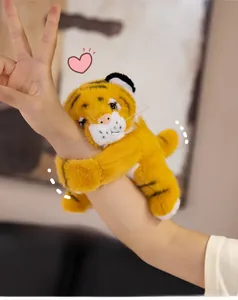 Plush tiger slap bracelet toy wrapping around a wrist with soft yellow fur texture