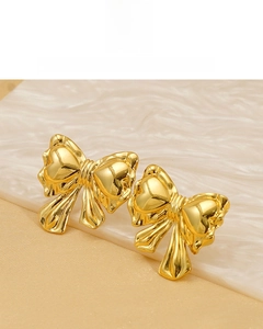 Detailed close-up of 18K gold plated bow earrings showing realistic metal textures