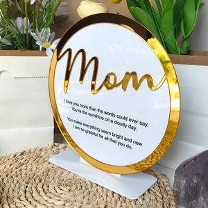 Close-up of Mother's Day round acrylic plaque with gold mirror Mom lettering and base