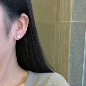 Close-up of S925 sterling silver drop earrings featuring 5A cubic zirconia on model
