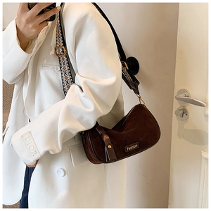 Detail of dark brown suede hobo bag with unique geometric pattern woven wide shoulder strap