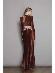 Detail of dark brown velvet long sleeve crop top with open back and metal chain waist