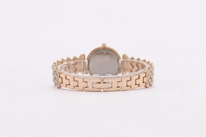 Detail of the golden watch band with crystal pavé and secure folding clasp closure