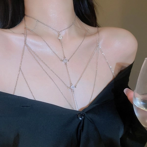 Close-up of multilayer silver body chain with sparkling diamond-shaped zircon accents