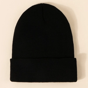Detailed texture of thick black knitted beanie with wide fold-over cuff design