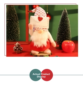 Detailed view of a Christmas gnome figurine holding a white heart envelope in festive setting