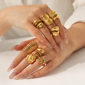 Elegant 18k gold plated stainless steel rings in assorted styles worn by a model