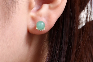 Detail shot of a green aventurine stone stud earring with crystal fan accents