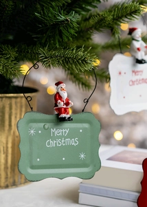 Detail of metal Christmas door sign featuring 3D Santa and Snowman on a festive background