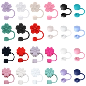 Grid of colorful silicone flower straw covers and round dust caps for Stanley cups