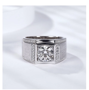Macro detail of men's silver ring with brushed metal texture and round moissanite