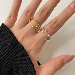 Irregular lava style two-tone ring and golden beaded open ring on model hand