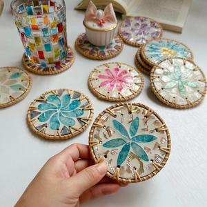 Detailed close-up of handmade rattan coasters with inlaid shell flower patterns