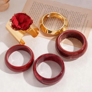 Vintage gold and burgundy resin bangle set with 3D floral detail in a 5-piece stack