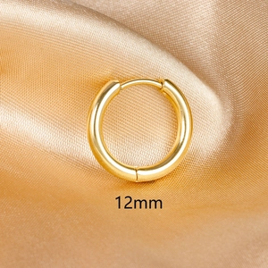 Close-up of 12mm gold chunky hoop earrings on satin background with snap closure