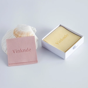 Pink velvet jewelry pouch set with yellow cleaning cloth and white drawer gift box