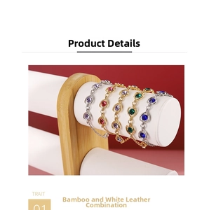 Close-up of bamboo and white leather display stand featuring pear-cut rhinestone bracelets