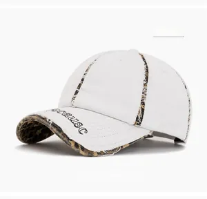 Close-up of white washed cotton baseball cap with leopard print brim and embroidery