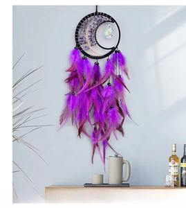 Detail of moon dreamcatcher with purple crystal stone tree and authentic soft feathers