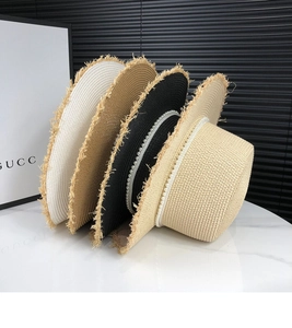 Detailed texture of woven straw hats featuring pearl bands in four elegant colors