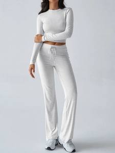 Detail of grey Y2K long sleeve top and drawstring wide-leg trousers on model