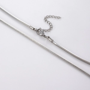 Detail of silver snake chain necklace with lobster clasp and adjustable extension link