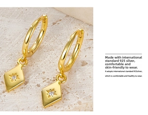 Detailed macro view of S925 sterling silver rhombic earrings with star-set zircon stones