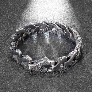 Close-up of a silver dragon bone punk chain bracelet with textured metal links