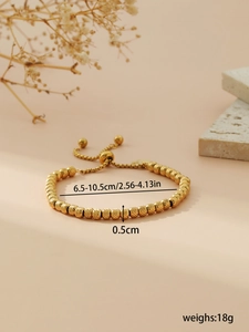 Detail view of adjustable gold beaded bracelet with dimensions and weight measurements