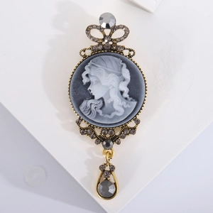 Vintage gold cameo brooch with royal crown design and grey drop pendant accessory