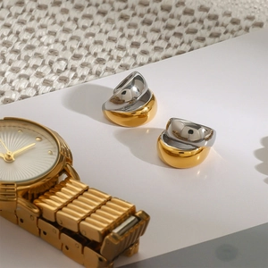 Detail showing two-tone gold and silver stackable chunky ear cuffs on knit fabric