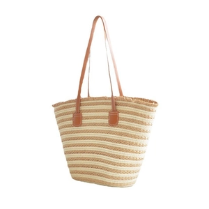Handwoven straw tote bag with beige and khaki stripes and brown leather handles