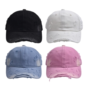 Distressed cotton baseball caps in black, white, blue, and pink colors with torn details