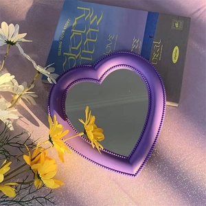 Purple heart-shaped desktop makeup mirror with beaded frame detail and wall-mount option