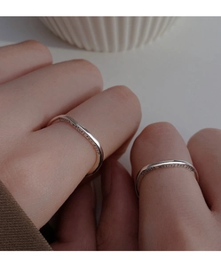 Close-up of S925 sterling silver wave ring engraved with Smooth waters run deep