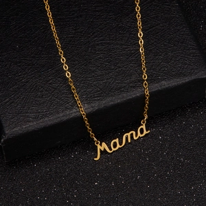 Macro shot of gold-plated cursive Mama pendant necklace on elegant jewelry display