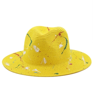 Artistic yellow straw Fedora hat with colorful paint splatter design for summer fashion