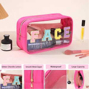 Detail view of pink PVC makeup bag with glitter chenille letters and smooth metal zipper