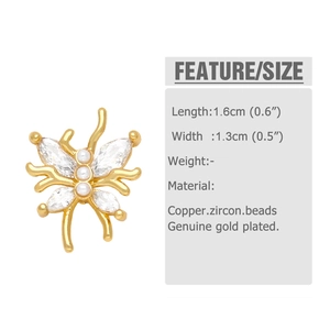 Macro detail of gold butterfly stud earrings with white zircon and pearls for women