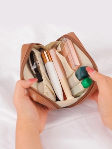 Detail view of the brown PU leather makeup bag showing internal storage for cosmetics