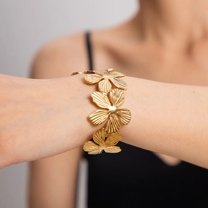 Elegant gold titanium flower link bracelet featuring detailed five-petal floral patterns