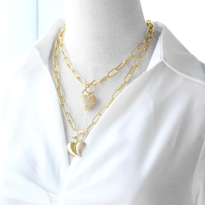Double-layered gold necklace with zircon heart pendant and thick chain on model