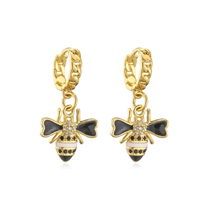 Close-up of 18K gold-plated bee earrings with black enamel and sparkling zircon details