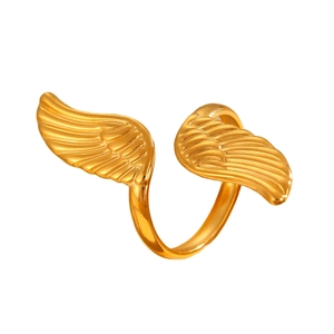 Macro view of golden adjustable angel wing ring with detailed feather texture engraving