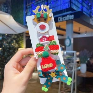 Close-up of 5-piece Christmas hair clips set featuring reindeer and bowknot on card