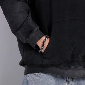 Gothic skull link bracelet in vintage silver finish shown on a male model's wrist