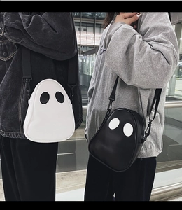 Close-up of ghost-shaped crossbody bag featuring contrast colors and smooth PU leather